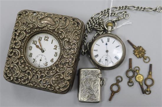 A pocket watch in silver travelling case, one other pocket watch, a silver vesta case and assorted watch keys.